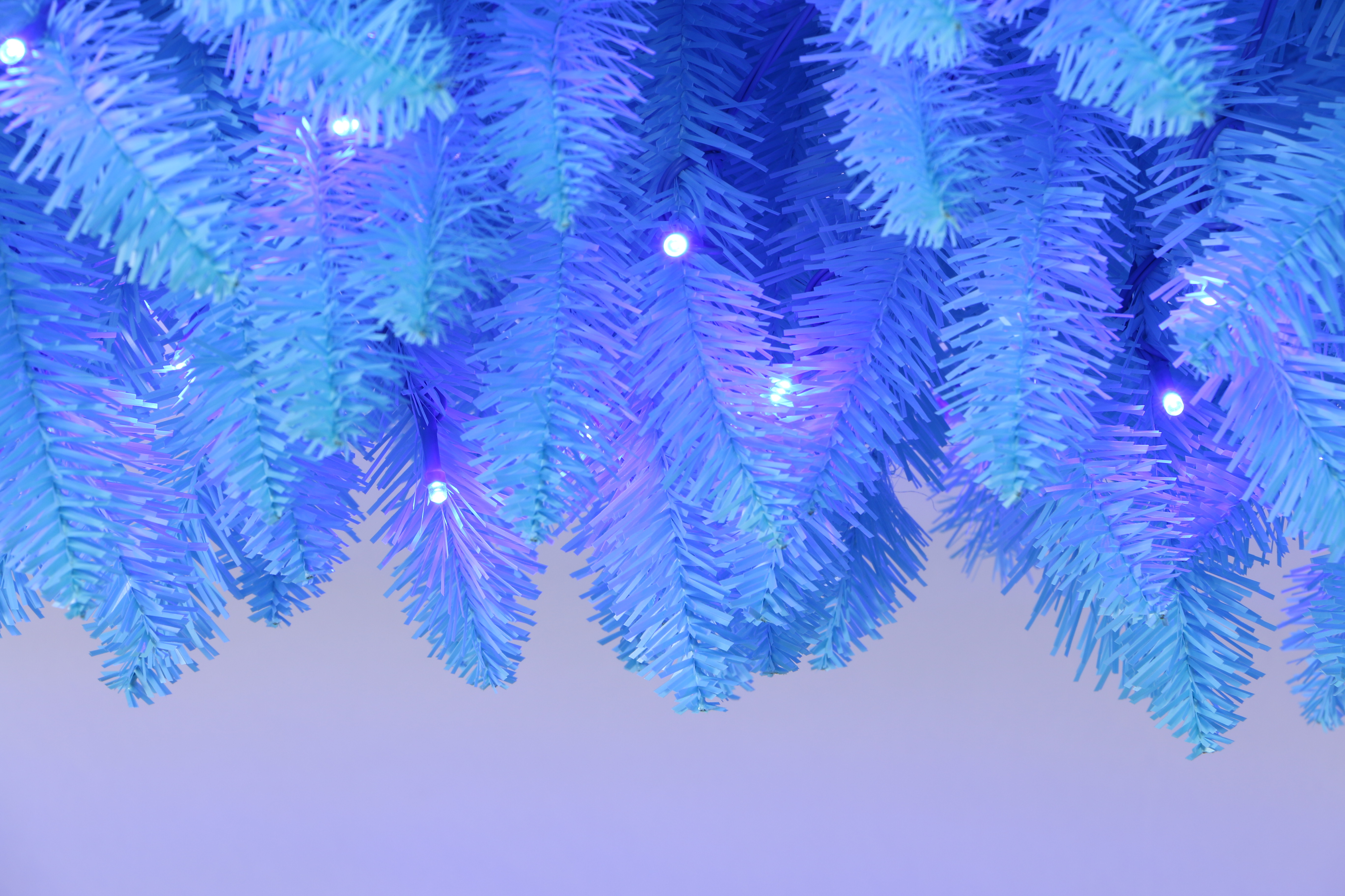 Elevate your holiday decor with the Trendy Tree 210cm Pre-lit Blue Pencil Christmas Tree. This slim, space-saving artificial tree features vibrant blue LED lights, a sturdy metal stand, and lush PVC needles. Perfect for home, office, and party Christmas displays.